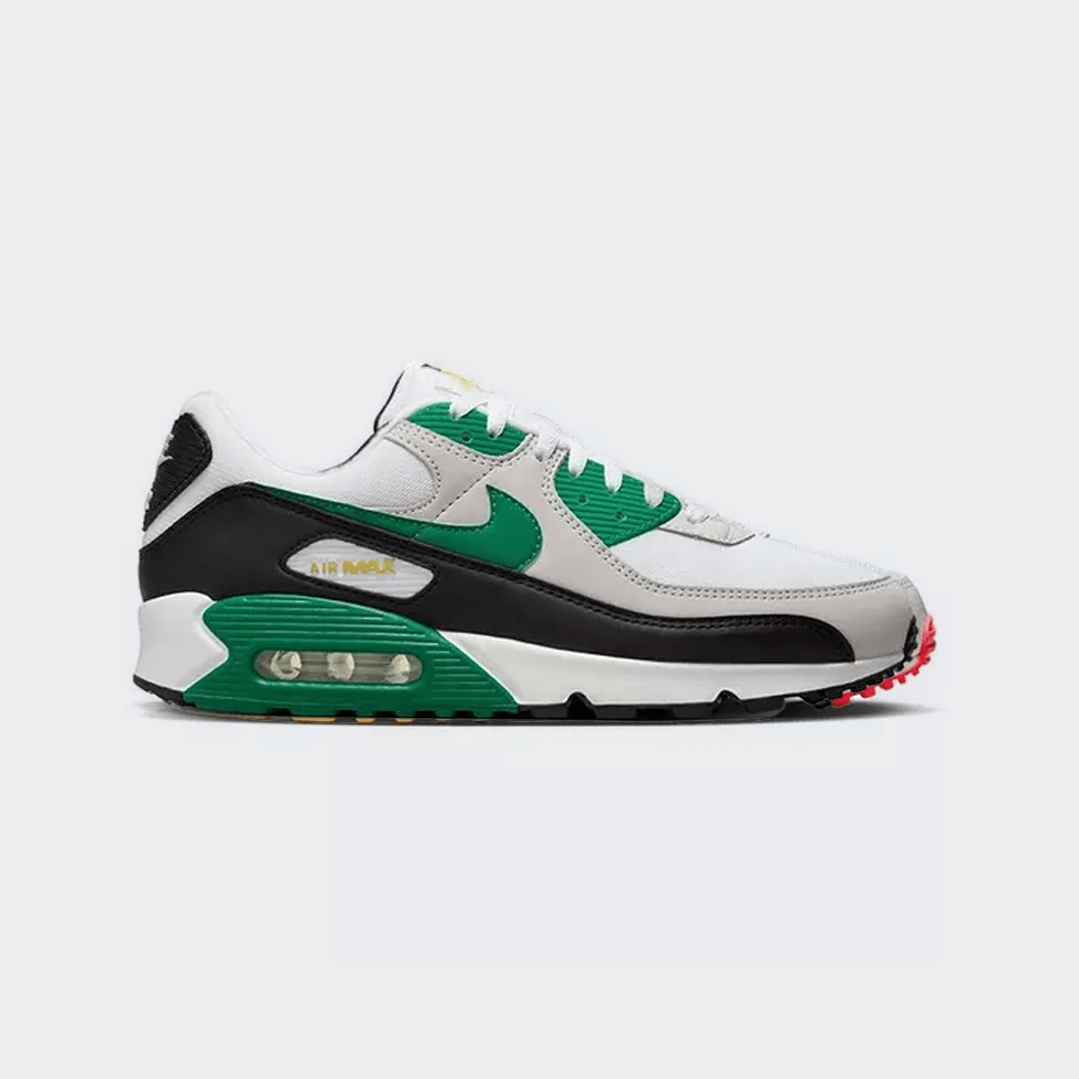 White, black, and green Nike Air Max 90 sneakers